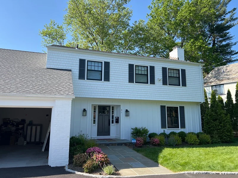 White Colonial In Scarsdale WIth Black Windows